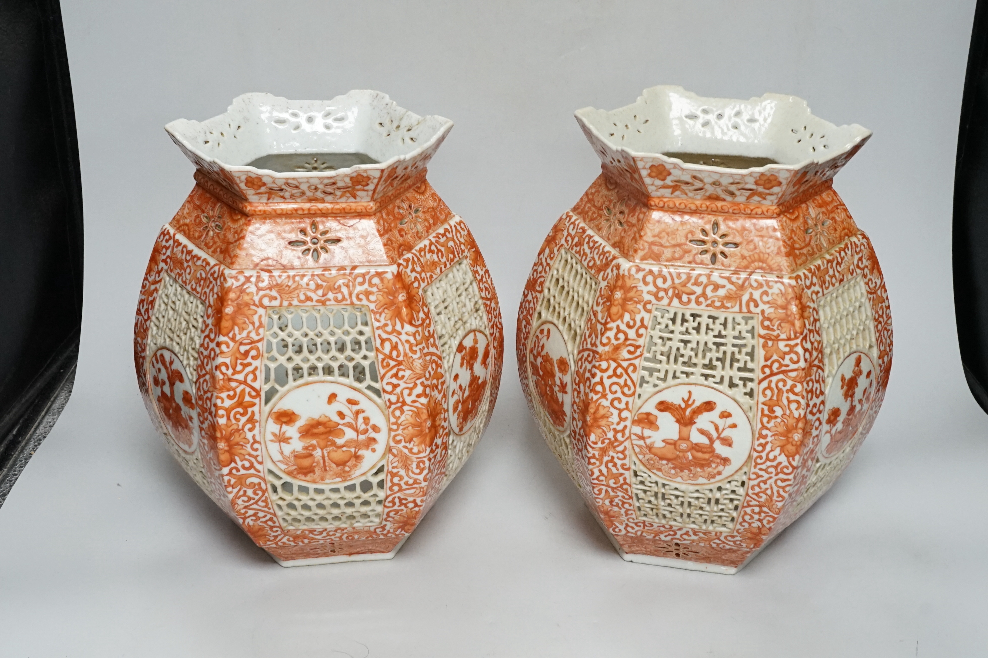 A pair of late 19th century Chinese reticulated and iron red enamelled lantern shades, 28cm